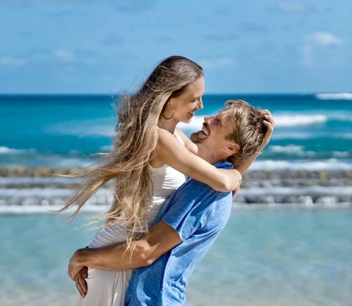 Couple embracing joyfully on the beach